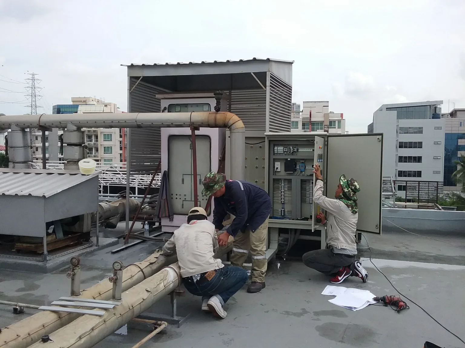 AIT engineers installing IoT sensors